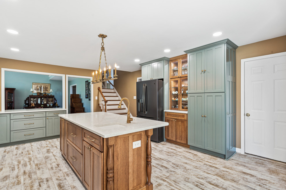 Example of a huge u-shaped light wood floor eat-in kitchen design in DC Metro with a farmhouse sink, recessed-panel cabinets, turquoise cabinets, quartz countertops, brick backsplash, black appliances, an island and white countertops
