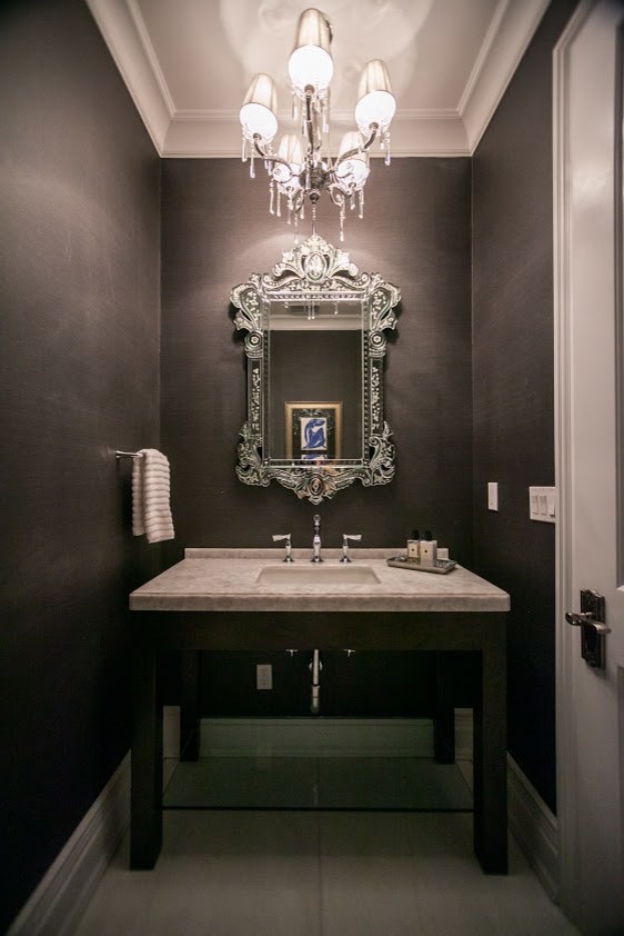 Design ideas for a mid-sized transitional powder room in New York with furniture-like cabinets, dark wood cabinets, marble benchtops, a one-piece toilet and gray tile.
