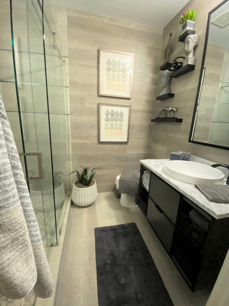 This is an example of a mid-sized modern 3/4 bathroom in Austin with gray tile, ceramic tile, a double shower, a vessel sink, a sliding shower screen, flat-panel cabinets, black cabinets, light hardwood floors, granite benchtops, beige floor and grey benchtops.