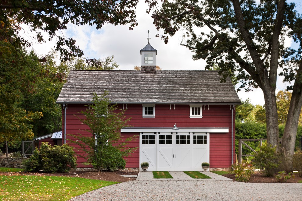 Country two-storey red exterior in New York with wood siding.