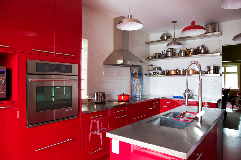 Design ideas for a large contemporary l-shaped kitchen pantry in Calgary with a double-bowl sink, flat-panel cabinets, red cabinets, stainless steel benchtops, white splashback, subway tile splashback, stainless steel appliances and with island.