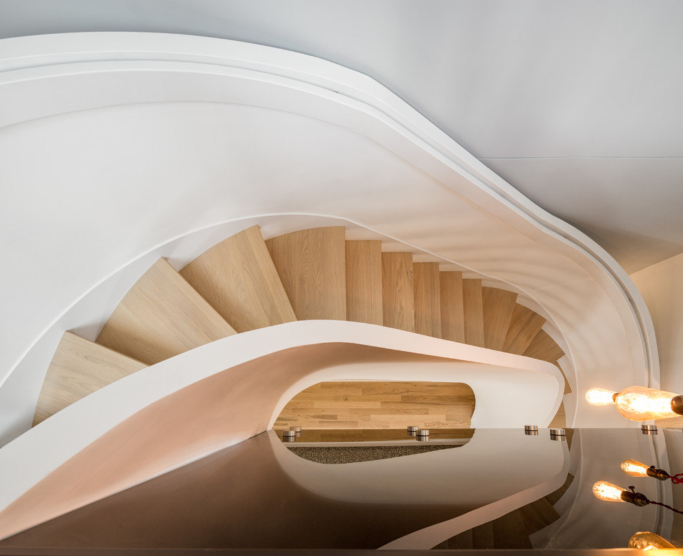 Mid-sized contemporary wood curved staircase in Ottawa.