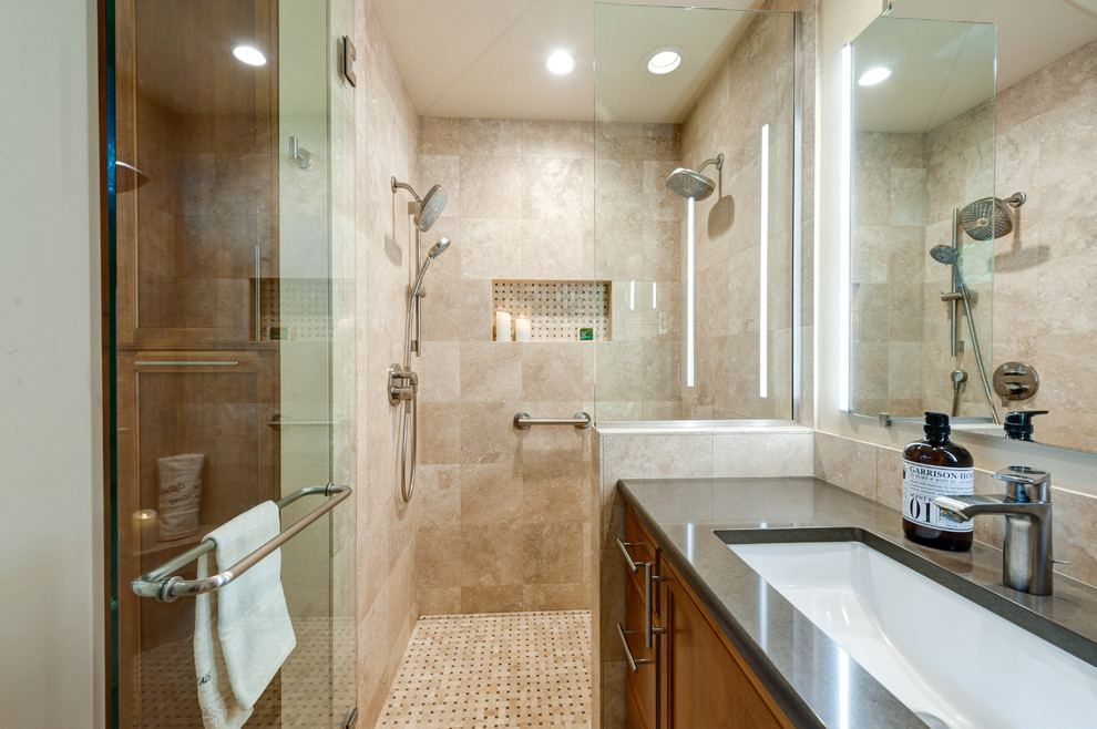 Small traditional master bathroom in Portland with raised-panel cabinets, medium wood cabinets, a curbless shower, a wall-mount toilet, beige tile, travertine, beige walls, travertine floors, an undermount sink, engineered quartz benchtops, multi-coloured floor and a hinged shower door.