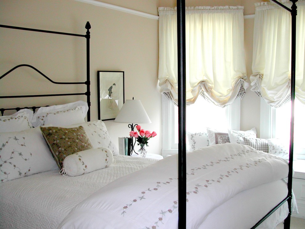 This is an example of a traditional bedroom in San Francisco with beige walls.
