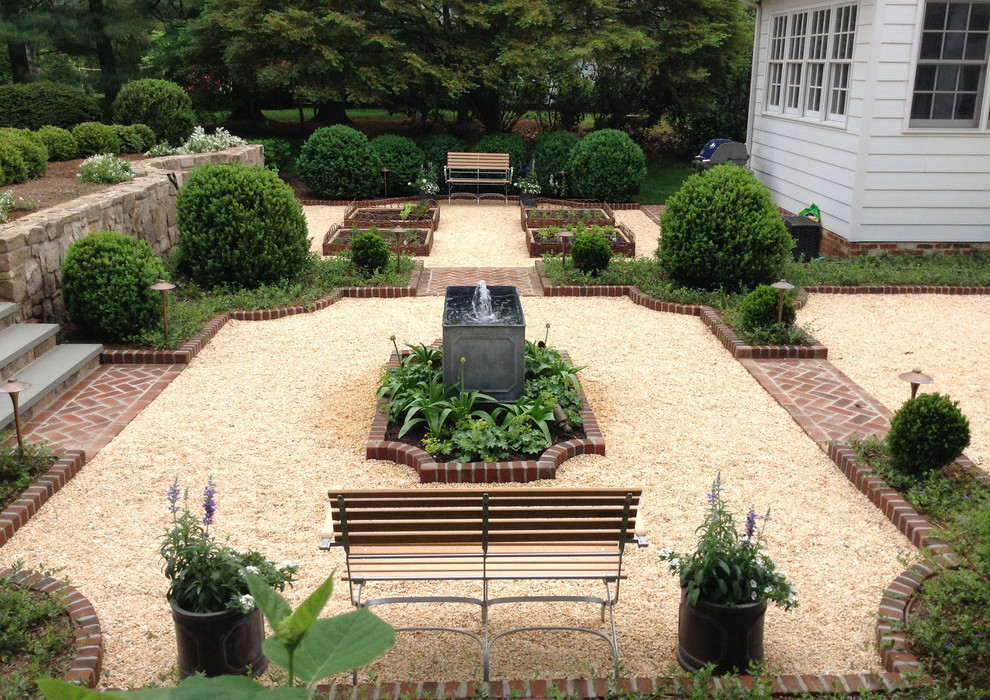 Design ideas for a large traditional courtyard full sun formal garden in DC Metro with gravel and a retaining wall.