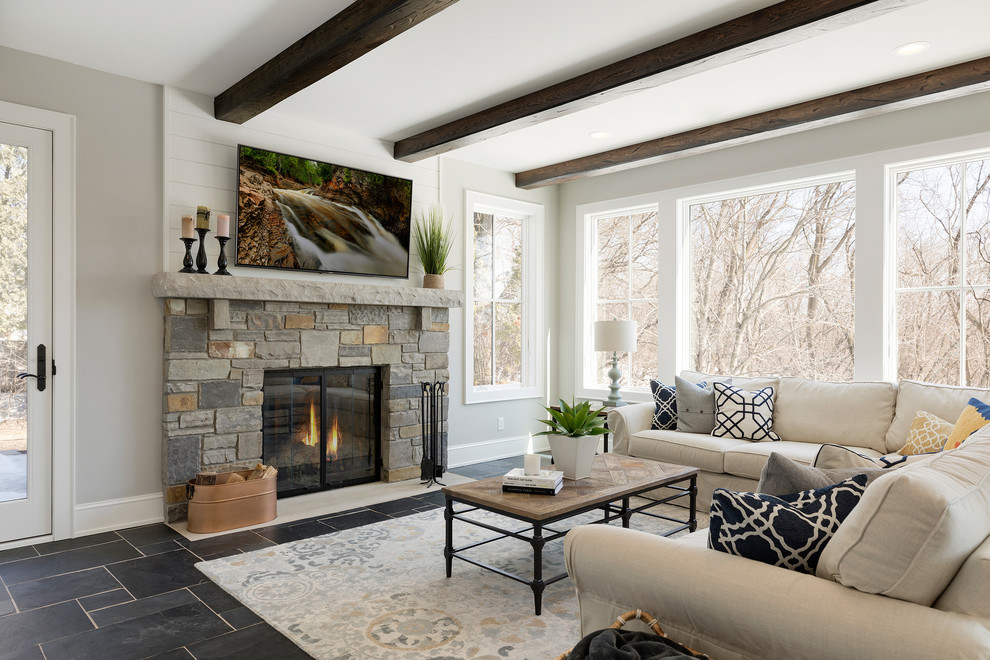 Design ideas for a large sunroom in Minneapolis with ceramic floors, a standard fireplace, a stone fireplace surround, a standard ceiling and grey floor.