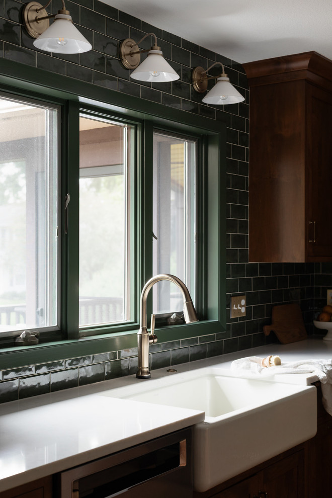 Kitchen pantry - mid-sized transitional l-shaped medium tone wood floor and brown floor kitchen pantry idea with a farmhouse sink, shaker cabinets, medium tone wood cabinets, quartz countertops, green backsplash, subway tile backsplash, stainless steel appliances, an island and white countertops
