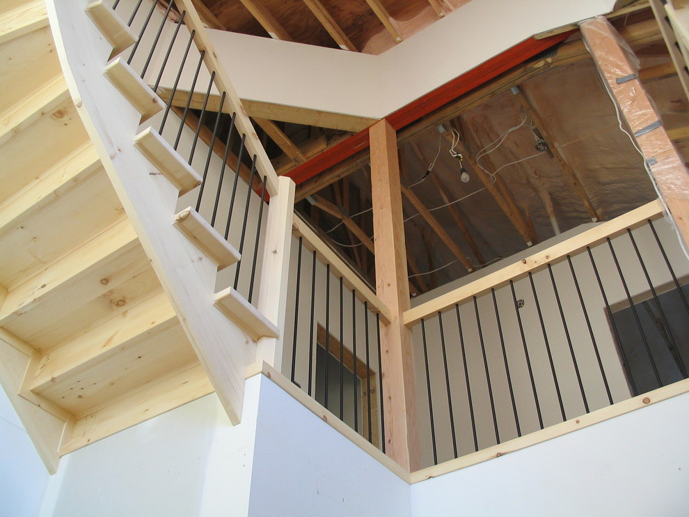 Huge mountain style wooden curved staircase photo with wooden risers