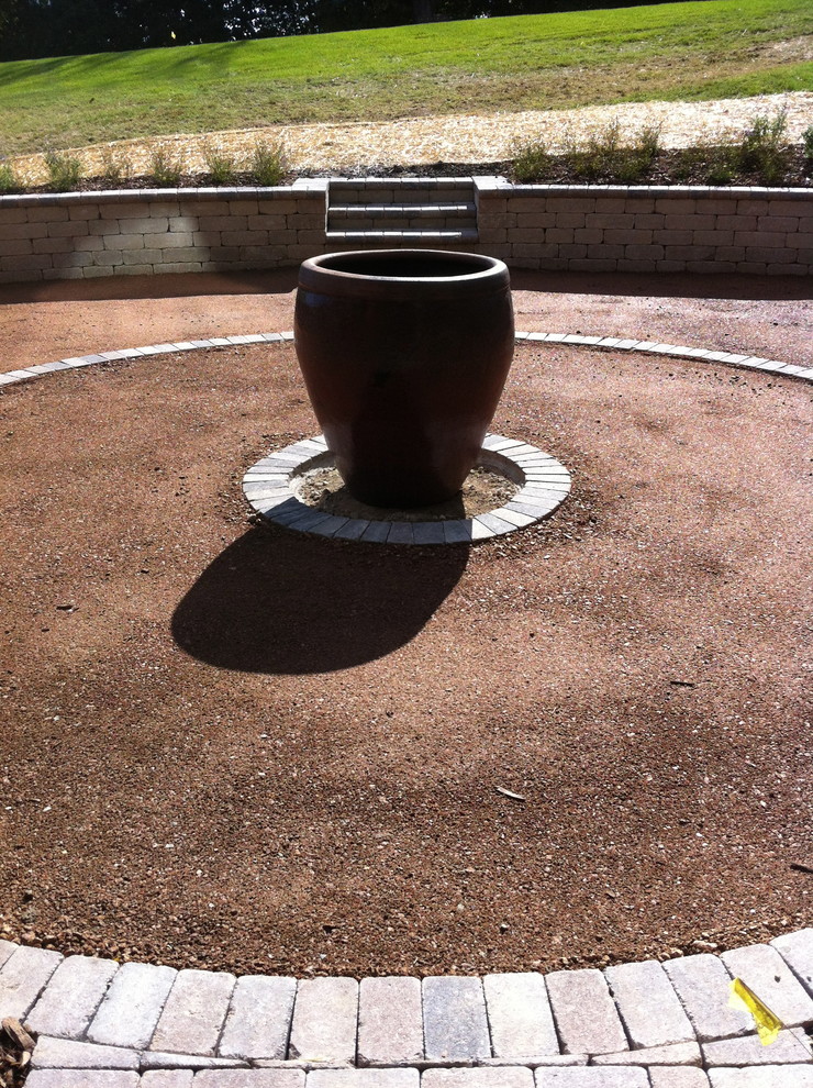 Inspiration for a mid-sized traditional backyard patio in Other with a water feature, decomposed granite and no cover.