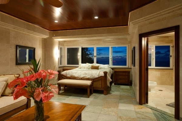 Inspiration for an expansive traditional guest bedroom in Hawaii with beige walls, travertine floors and no fireplace.