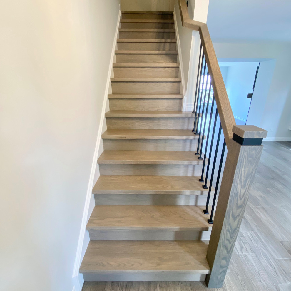 Example of a transitional wooden straight mixed material railing staircase design with wooden risers