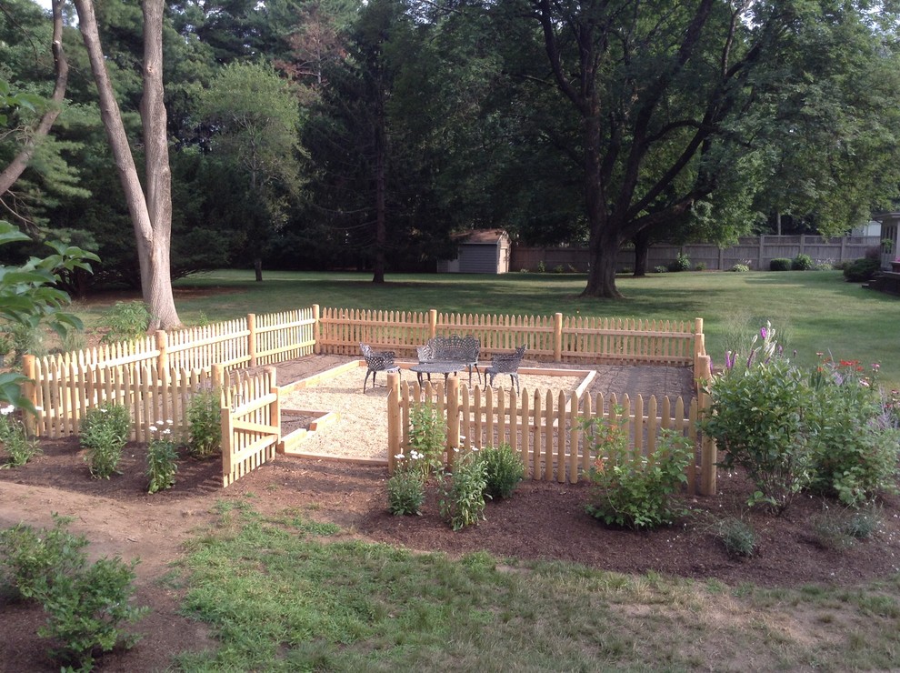 This is an example of a large country backyard patio in Boston with a vegetable garden, gravel and no cover.