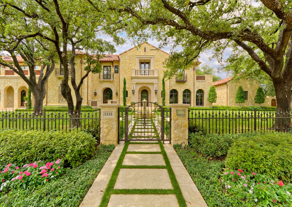 This is an example of a mediterranean exterior in Dallas with stone veneer.