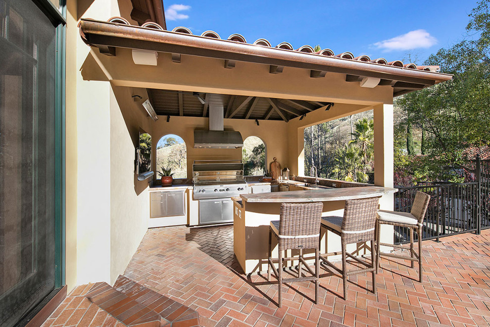 Medium sized mediterranean back patio in San Francisco with an outdoor kitchen, brick paving and a roof extension.