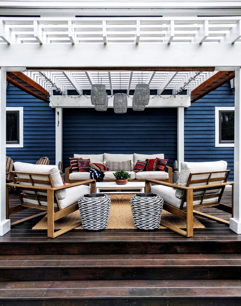 Design ideas for an expansive eclectic backyard deck in New York with a pergola.