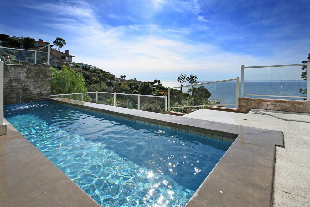 Contemporary rectangular pool in Orange County with concrete slab.