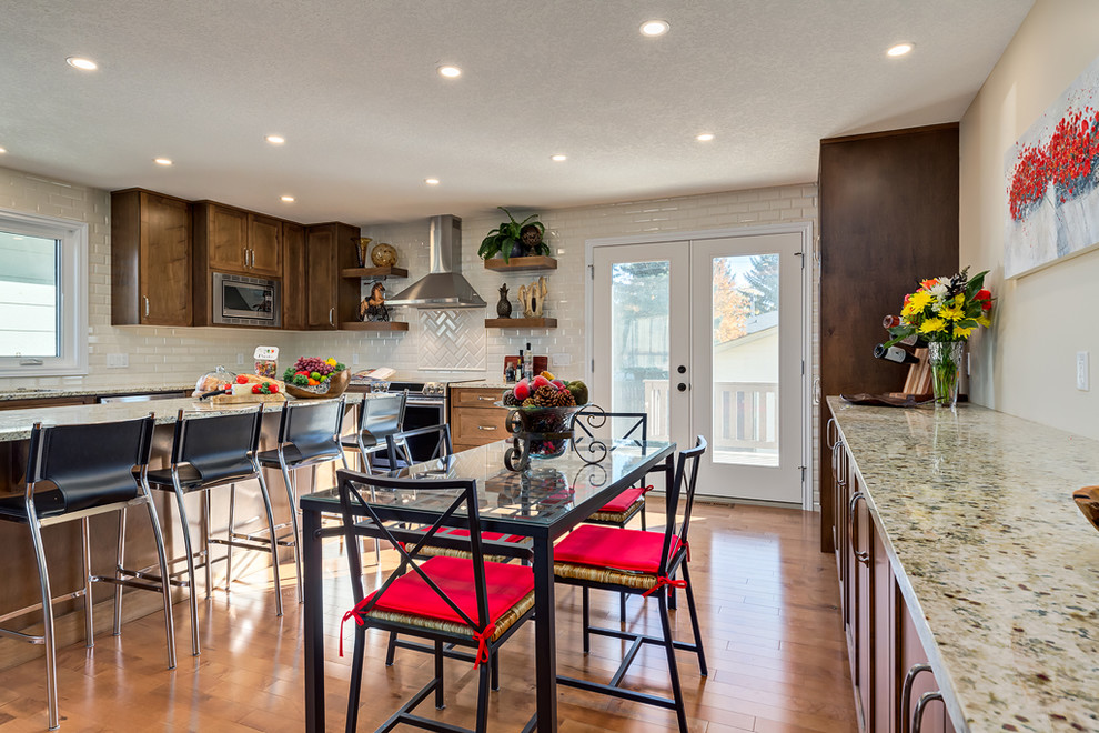 Example of a transitional home design design in Calgary