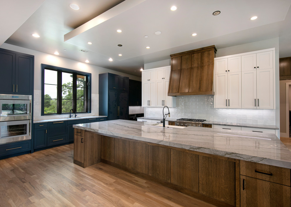 Inspiration for a large transitional u-shaped eat-in kitchen remodel in Dallas with flat-panel cabinets, dark wood cabinets, quartz countertops, white backsplash, stainless steel appliances, an island and gray countertops