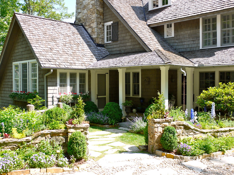 Inspiration for a front yard stone retaining wall landscape in Other.