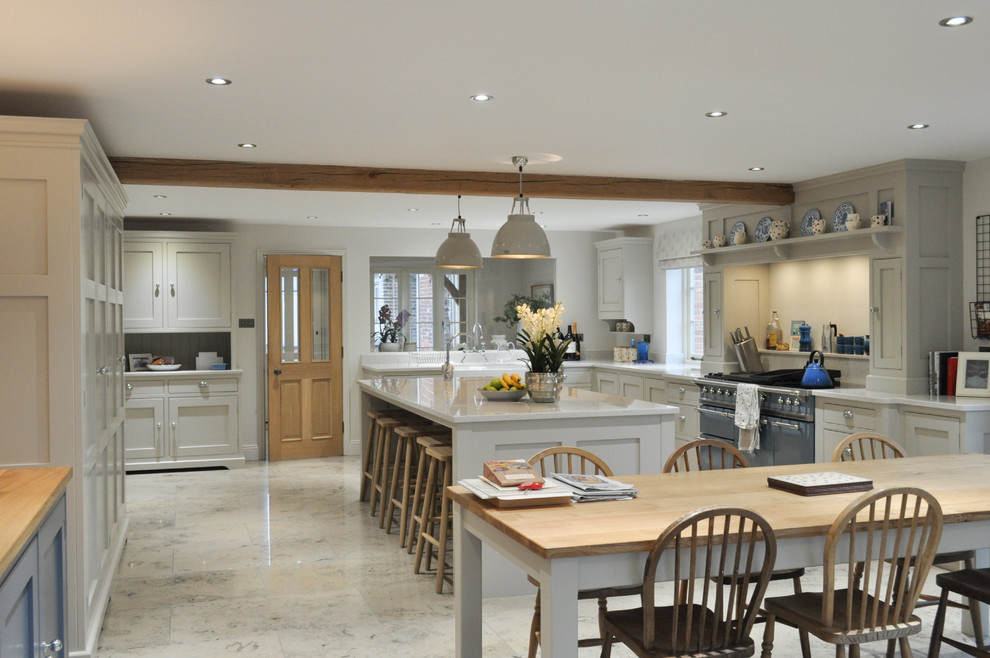 Design ideas for an expansive traditional l-shaped open plan kitchen in Other with a farmhouse sink, shaker cabinets, grey cabinets, quartzite benchtops, coloured appliances, limestone floors and with island.