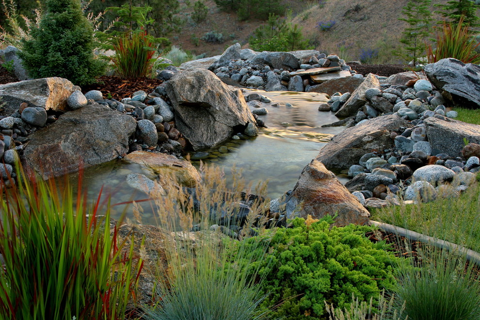 Inspiration for a large contemporary backyard garden in Seattle with a water feature and natural stone pavers.