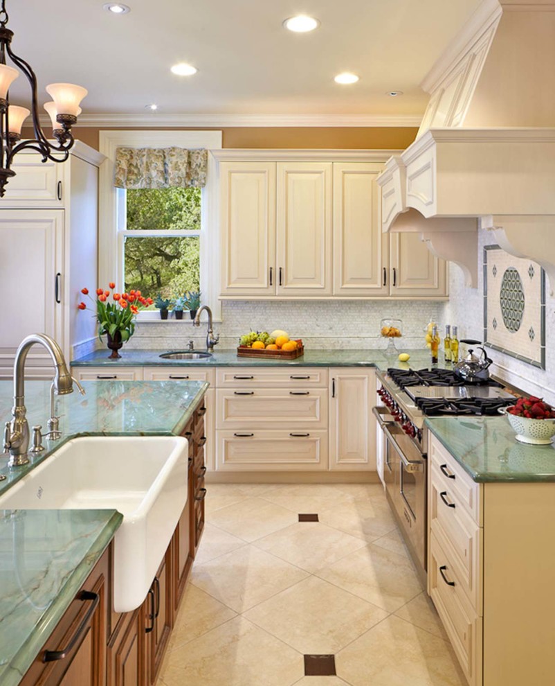 Photo of an expansive traditional u-shaped eat-in kitchen in San Francisco with raised-panel cabinets, white cabinets, quartzite benchtops, white splashback, stone tile splashback, panelled appliances, porcelain floors, with island and a farmhouse sink.
