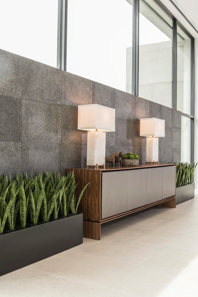 Example of a large minimalist open concept porcelain tile and beige floor living room design in Phoenix with white walls, a hanging fireplace, a stone fireplace and a wall-mounted tv
