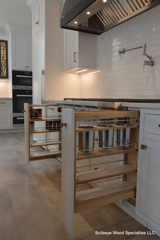 Inspiration for a large transitional l-shaped porcelain tile and beige floor open concept kitchen remodel in DC Metro with a farmhouse sink, recessed-panel cabinets, white cabinets, quartz countertops, white backsplash, ceramic backsplash, paneled appliances, an island and white countertops