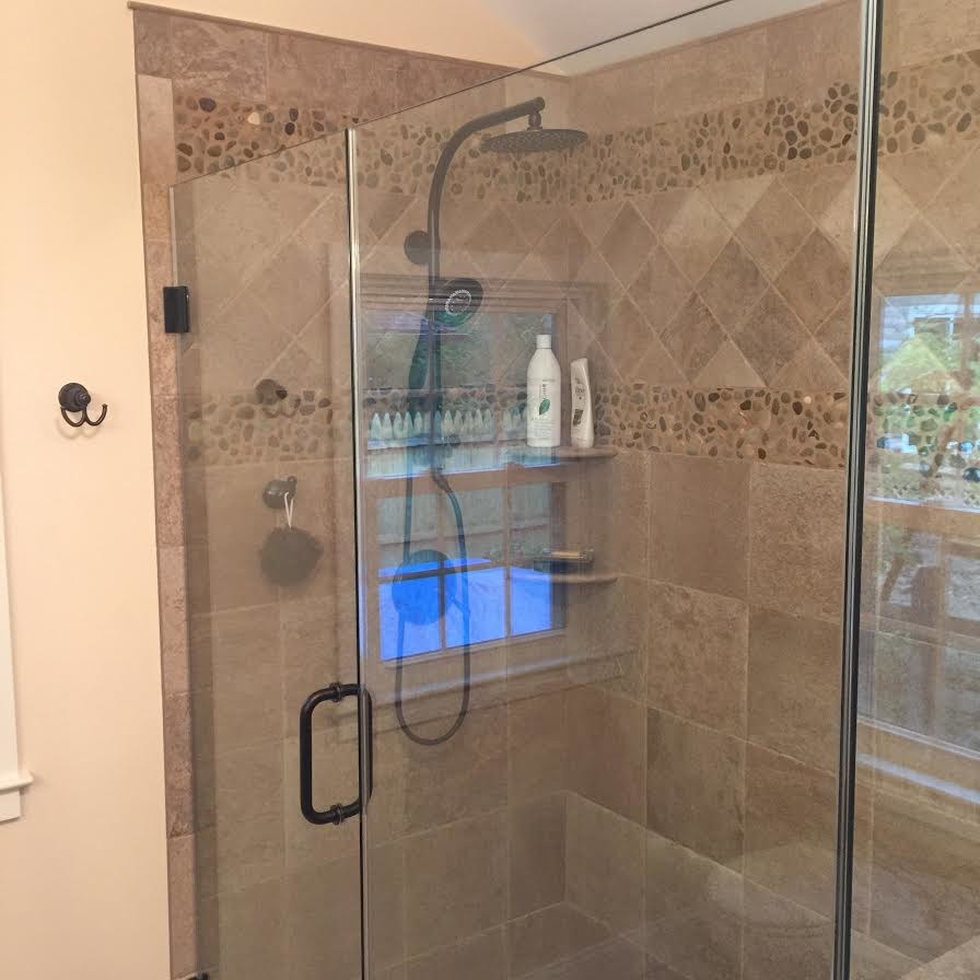 Contemporary bathroom in Philadelphia with beige tile, pebble tile and an alcove shower.