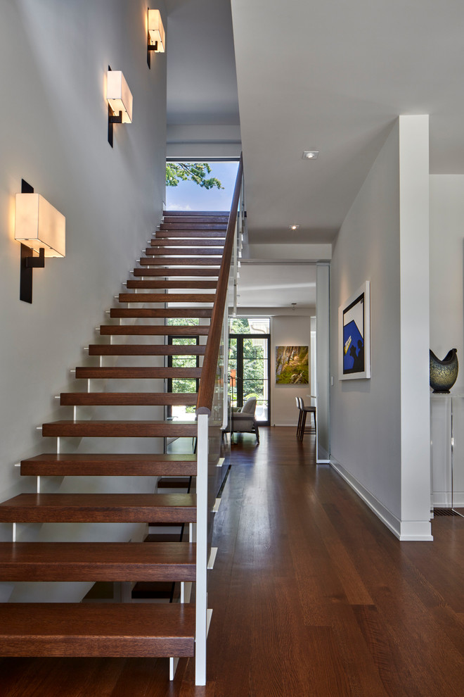 Inspiration for a contemporary wood straight staircase in Atlanta with open risers and glass railing.
