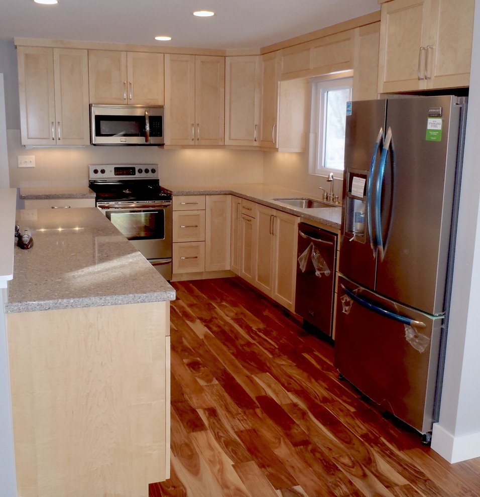 Inspiration for a mid-sized light wood floor kitchen remodel in Denver with light wood cabinets and white backsplash