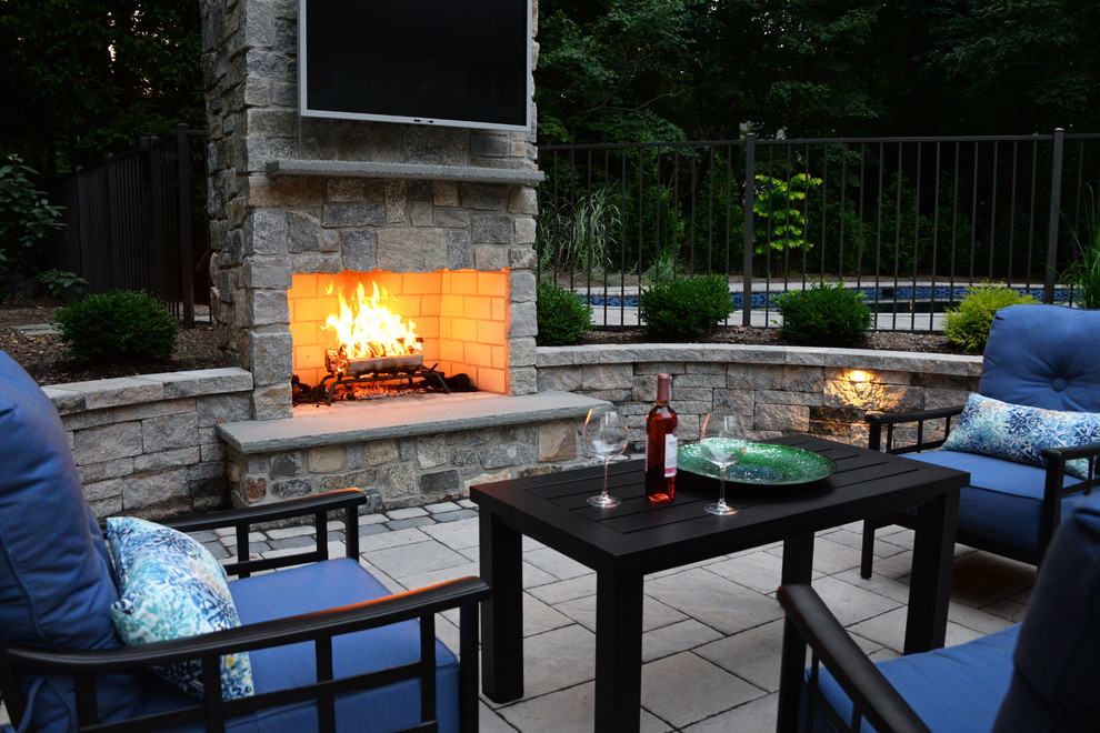 Photo of a modern backyard patio in Other with a fire feature.