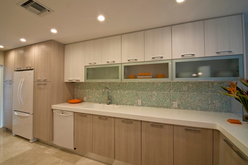 Design ideas for a mid-sized contemporary galley eat-in kitchen in Tampa with an undermount sink, flat-panel cabinets, light wood cabinets, solid surface benchtops, blue splashback, glass tile splashback, white appliances, marble floors and a peninsula.
