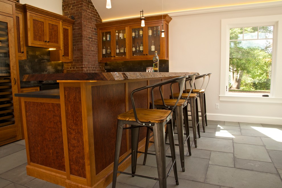 Inspiration for a large country u-shaped seated home bar in Boston with an undermount sink, shaker cabinets, medium wood cabinets and stone tile splashback.