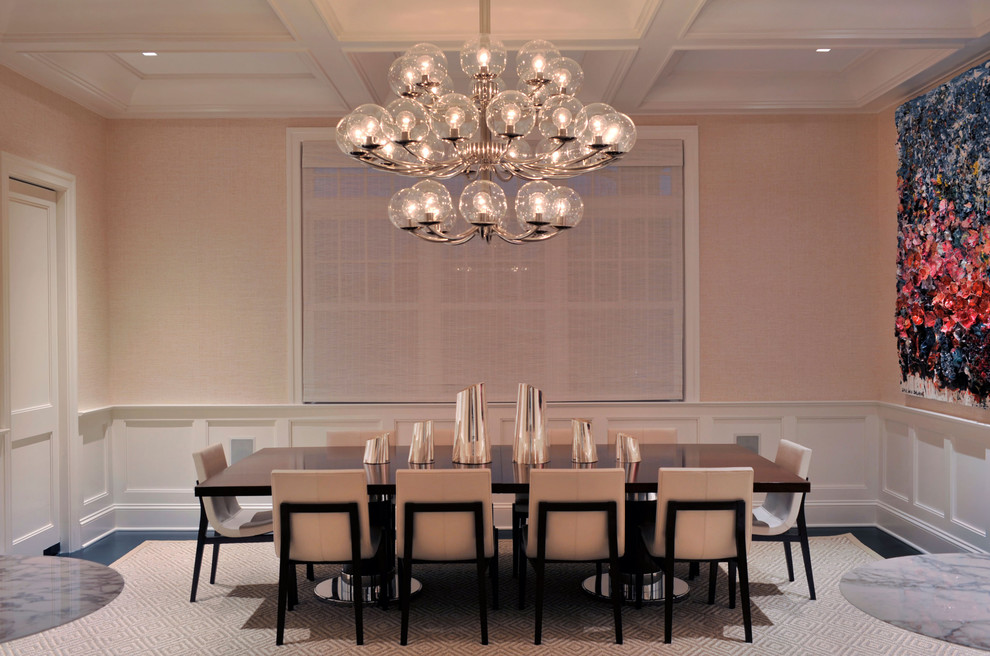 This is an example of a transitional separate dining room in New York with pink walls and no fireplace.