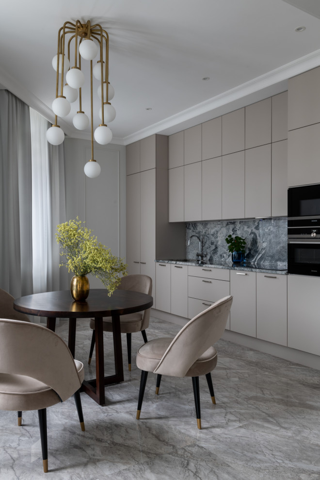 This is an example of a mid-sized contemporary single-wall eat-in kitchen in Moscow with an undermount sink, flat-panel cabinets, beige cabinets, granite benchtops, grey splashback, granite splashback, black appliances, marble floors, no island, grey floor and grey benchtop.