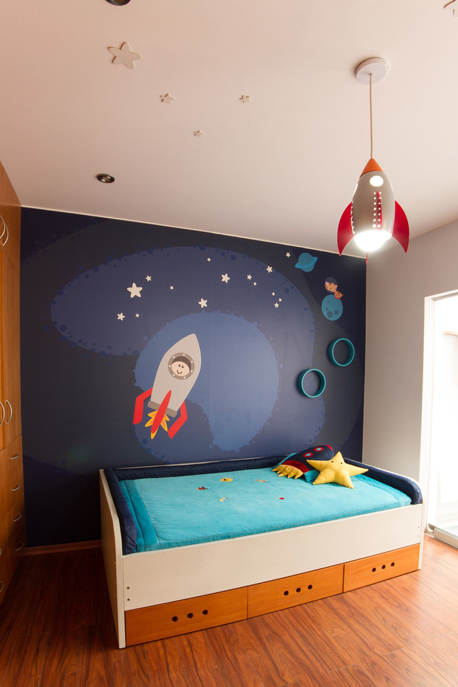 Inspiration for a contemporary kids' room for boys in Other with grey walls and medium hardwood floors.