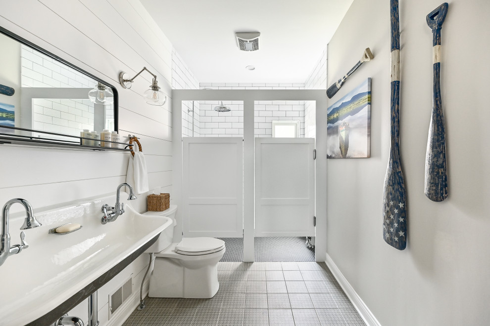 This is an example of a medium sized nautical shower room bathroom in Milwaukee with a built-in shower, a two-piece toilet, white walls, porcelain flooring, a wall-mounted sink, black floors, a hinged door, a wall niche, double sinks, a floating vanity unit and tongue and groove walls.
