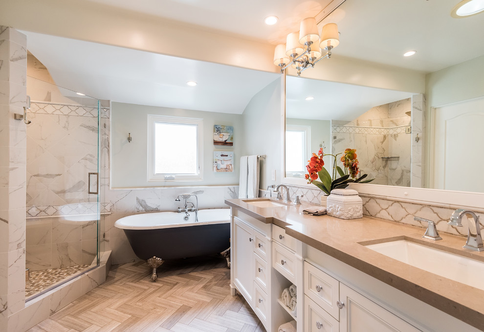 Design ideas for a traditional bathroom in Los Angeles with recessed-panel cabinets, white cabinets, a claw-foot tub, a corner shower, white tile, grey walls, an undermount sink, brown floor, a hinged shower door and beige benchtops.