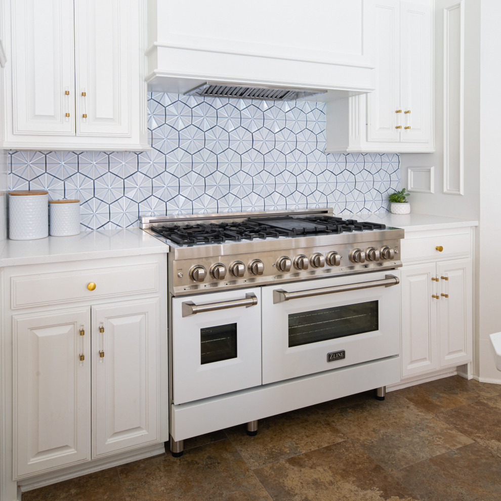 Photo of a mid-sized traditional kitchen in Dallas with an undermount sink, raised-panel cabinets, white cabinets, quartz benchtops, blue splashback, ceramic splashback, white appliances, multiple islands and white benchtop.