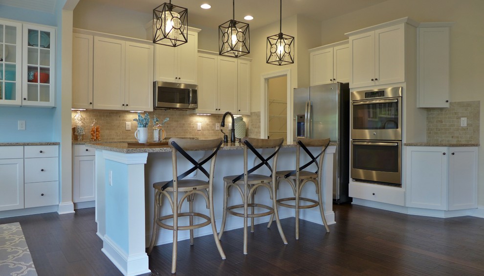 Open concept kitchen - mid-sized transitional l-shaped dark wood floor and brown floor open concept kitchen idea in Richmond with an undermount sink, shaker cabinets, white cabinets, granite countertops, beige backsplash, marble backsplash, stainless steel appliances, an island and multicolored countertops