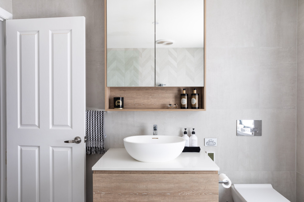 This is an example of a large contemporary kids bathroom in Sydney with flat-panel cabinets, light wood cabinets, a vessel sink, engineered quartz benchtops, an open shower, white benchtops, a niche, a double vanity and a floating vanity.