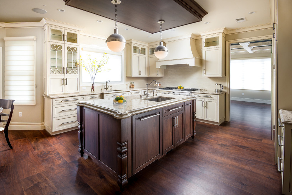 Eat-in kitchen - mid-sized traditional l-shaped plywood floor eat-in kitchen idea in New York with glass-front cabinets, light wood cabinets, granite countertops, beige backsplash, stainless steel appliances, an island and ceramic backsplash