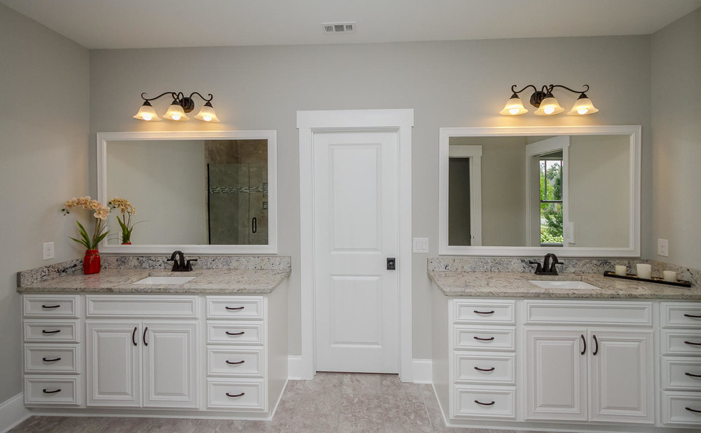 Large contemporary bathroom in Atlanta with raised-panel cabinets, white cabinets, an alcove tub, beige tile, glass tile, grey walls, ceramic floors and granite benchtops.