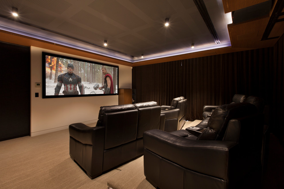 Photo of a mid-sized contemporary home theatre in Melbourne with white walls, carpet and a projector screen.