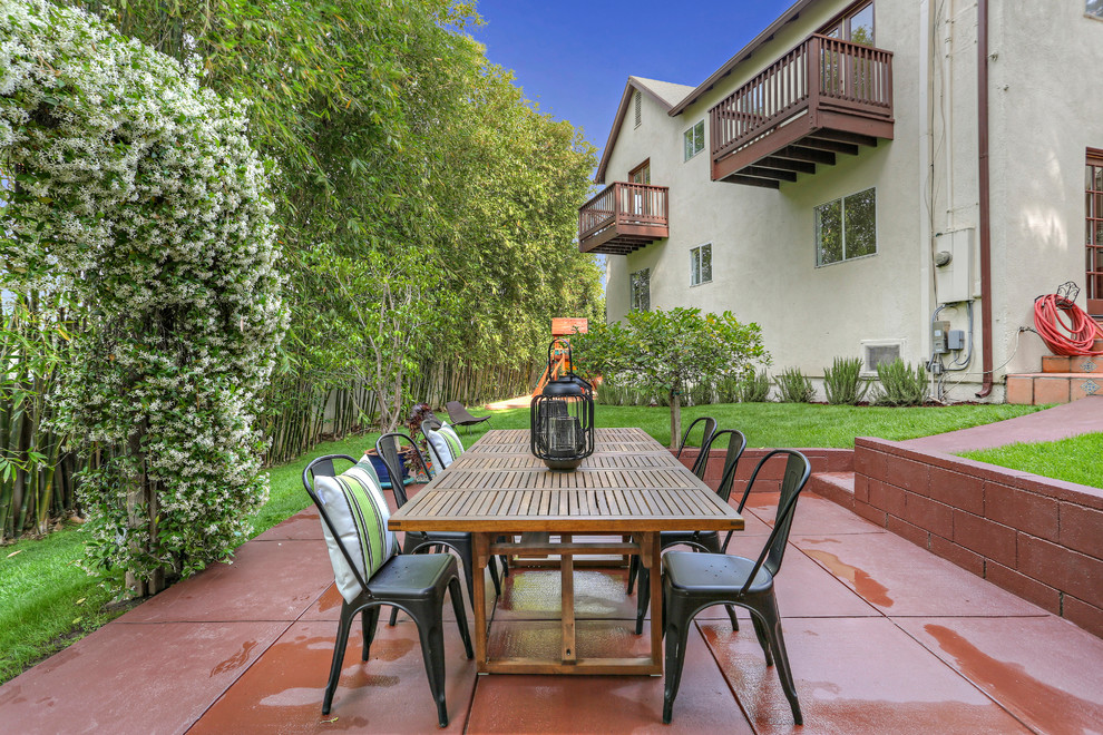 Inspiration for a transitional side yard concrete patio remodel in Los Angeles with no cover