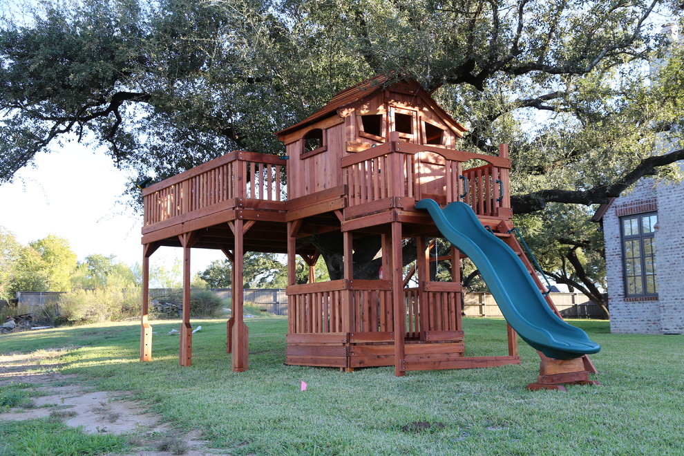 This is an example of a large arts and crafts backyard shaded outdoor sport court for summer in Dallas with with outdoor playset.