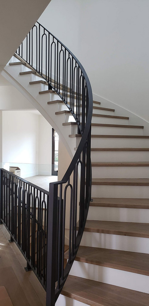 Design ideas for a mid-sized modern wood curved staircase in San Francisco with metal railing.