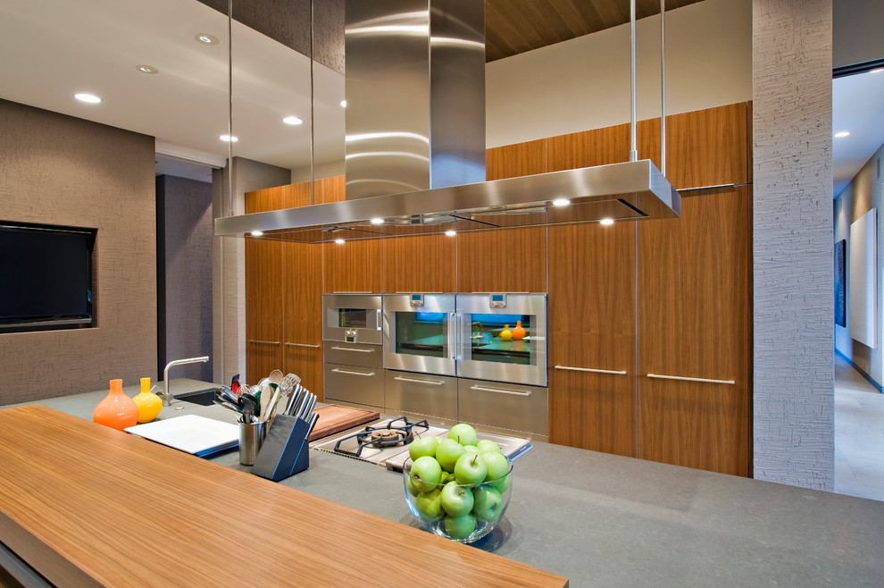 Inspiration for a large contemporary l-shaped open plan kitchen in San Francisco with an undermount sink, flat-panel cabinets, light wood cabinets, zinc benchtops, stainless steel appliances, porcelain floors, with island and beige floor.