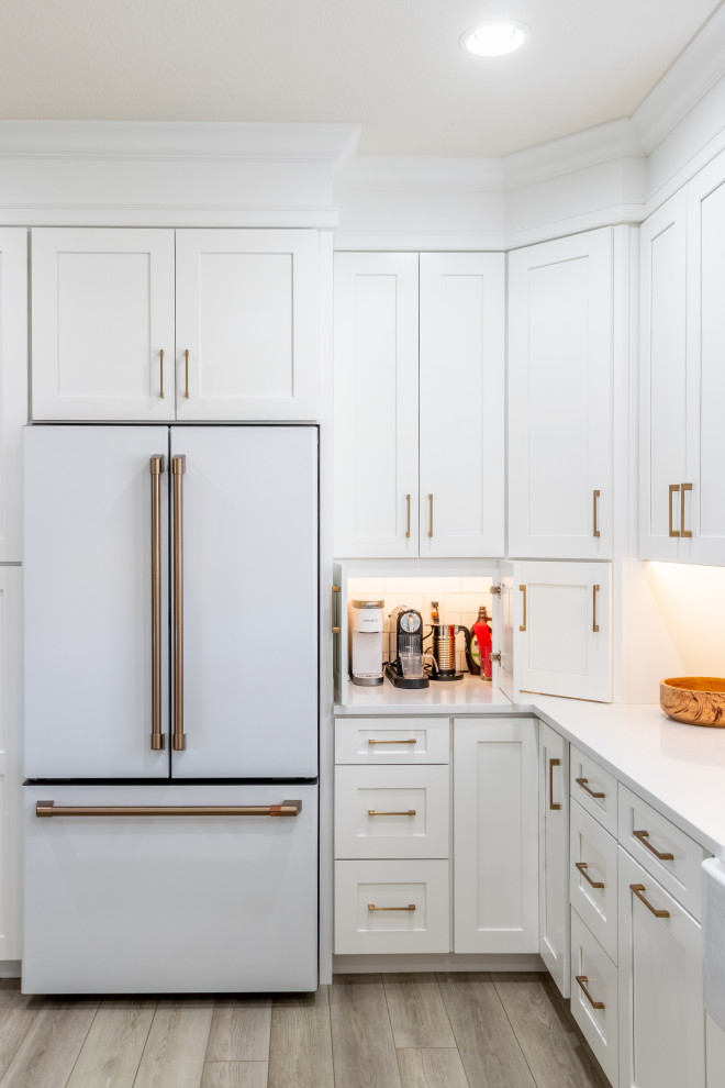 Example of a transitional kitchen design in Phoenix with shaker cabinets, white cabinets, quartz countertops, white backsplash, white appliances and white countertops
